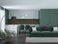 Nowoczesny salon z kuchnią, gdzie dominują zielony kolor ścian i mebli. Wygodna sofa, fotele i stół z krzesłami tworzą przytulną przestrzeń.
