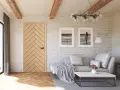Jasne, oto opis:

Salon w stylu modern farmhouse z drewnianą podłogą w jodełkę, ceglaną ścianą i dwoma obrazami z motywem morza.