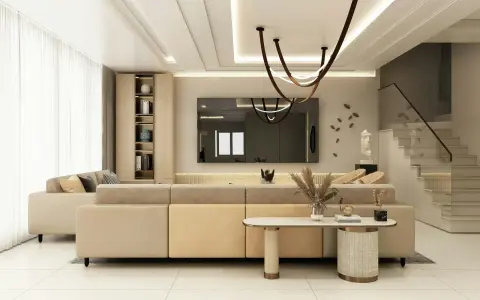 Nowoczesny salon z beżową kanapą i schodami. Inspiracje malowanie ścian w neutralnych kolorach.