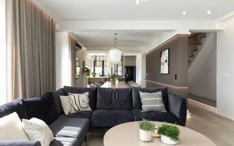 Nowoczesny salon z wygodną kanapą i stolikiem kawowym. Inspiracja, jak urządzić salon w eleganckim stylu.
