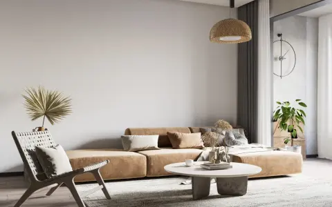 Wabi-sabi wnętrza: beżowa kanapa, pleciony fotel, suszone trawy i palma tworzą przytulną, naturalną przestrzeń.