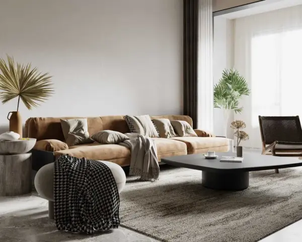 Salon w stylu wabi sabi: brązowa kanapa, kamienny stolik, pleciony fotel i suszone rośliny tworzą przytulną, niedoskonałą przestrzeń.