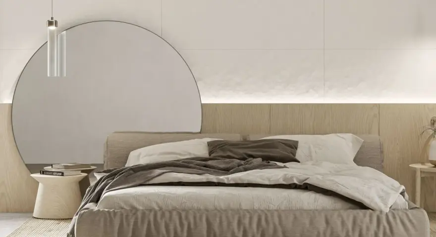 Przytulna sypialnia inspiracje: minimalistyczne łóżko z lnianą pościelą, okrągłe lustro i drewniana ściana tworzą spokojną atmosferę.