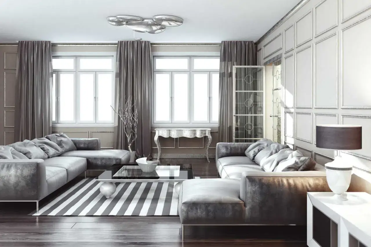 Elegancki salon z szarymi meblami i zasłonami. Pytanie: jaki kolor pasuje do srebrnego? Odpowiedź: szarość i biel tworzą harmonijną całość.